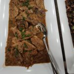 Seared sliced pork with caramelized onions and pan gravy