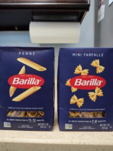 Two side-by-side blue boxes with Penne and Mini Farfalle pasta by Barilla